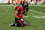 MIAMI GARDENS, FL - NOVEMBER 15:  Linebacker Niko Koutouvides #53 of the Tampa Bay Buccaneers reacts after failing to make a tackle against the Miami Dolphins at Land Shark Stadium on November 15, 2009 in Miami Gardens, Florida.  (Photo by Doug Benc/Getty Images)