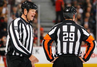 OTTAWA, ON - NOVEMBER 10:  Referees Scott Driscolll and Ian Walsh talk on the ice during the game between the Edmonton Oilers and the Ottawa Senators in a game at Scotiabank Place on November 10, 2009 in Ottawa, Canada.  (Photo by Phillip MacCallum/Getty Images)
