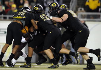 EUGENE,OR - NOVEMBER 14: Linebacker Eddie Pleasant #11, linebacker Casey Matthews #55 and defensive tackle Brandon Bair #88 of the Oregon Ducks gang up to tackle running back Dimitri Nance #31of the Arizona State Sun Devils in the first quarter of the game at Autzen Stadium on November 14, 2009 in Eugene, Oregon. (Photo by Steve Dykes/Getty Images)