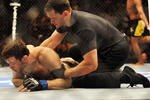 PHILADELPHIA - AUGUST 08:  (Bottom) Forrest Griffin on the ground after being defeated by Anderson Silva during their light heavyweight bout at UFC 101: Declaration at the Wachovia Center on August 8, 2009 in Philadelphia, Pennsylvania.  (Photo by Jon Kopaloff/Getty Images)