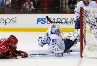 RALEIGH, NC - NOVEMBER 19: Jonas Gustavsson #50 of the Toronto Maple Leafs can't stop a second period shot by Stephane Yelle #18 of the Carolina Hurricanes at the RBC Center on November 19, 2009 in Raleigh, North Carolina. (Photo by Bruce Bennett/Getty Images)