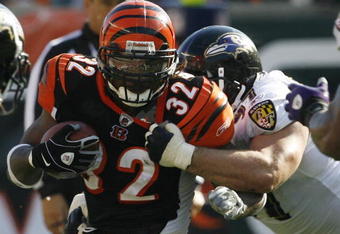 CINCINNATI - NOVEMBER 8: Cedric Benson #32 of the Cincinnati Bengals is tackled by Kelly Gregg #97 of the Baltimore Ravens at Paul Brown Stadium on November 8, 2009 in Cincinnati, Ohio.  (Photo by John Sommers II/Getty Images)