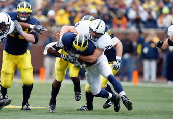 ANN ARBOR, MI - OCTOBER 24:  Josh Hull #43 of the Penn State Nittany Lions tackles Brandon Minor #4 of the Michigan Wolverines on October 24, 2009 at Michigan Stadium in Ann Arbor, Michigan. (Photo by  Gregory Shamus/Getty Images)