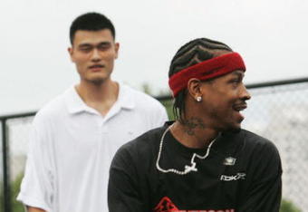 SHANGHAI, CHINA - SEPTEMBER 25: (CHINA OUT) NBA star Allen Iverson (R) of USA and Yao Ming of China play basketball with fans during an event at Shanghai Stadium on September 25, 2005 in Shanghai, China. Philadelphia 76ers guard Allen Iverson is visiting Shanghai as the last leg of his Asia Tour which lasts from September 21 to 26. (Photo by China Photos/Getty Images) 