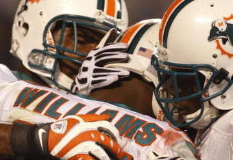 CHARLOTTE - NOVEMBER 19: Ricky Williams #34 of the Miami Dolphins celebrates with teammates after he scored on a 14 yard touchdown reception in the second quarter against the Carolina Panthers at Bank of America Stadium on November 19, 2009 in Charlotte, North Carolina.  (Photo by Streeter Lecka/Getty Images)