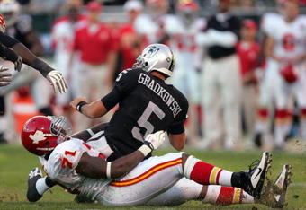 OAKLAND, CA - NOVEMBER 15:  Bruce Gradkowski #5 of the Oakland Raiders is sacked by Alex Magee #71 of the Kansas City Chiefs at Oakland-Alameda County Coliseum on November 15, 2009 in Oakland, California.  (Photo by Ezra Shaw/Getty Images)