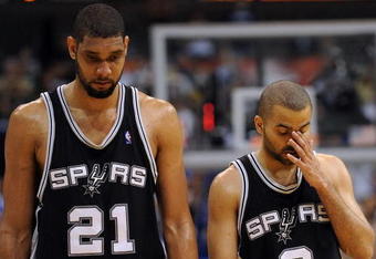 DALLAS - APRIL 25:  Forward Tim Duncan #21 and Tony Parker #9 of the San Antonio Spurs during a 99-90 loss against the Dallas Mavericks in Game Four of the Western Conference Quarterfinals during the 2009 NBA Playoffs at American Airlines Center on April 25, 2009 in Dallas, Texas. NOTE TO USER: User expressly acknowledges and agrees that, by downloading and or using this photograph, User is consenting to the terms and conditions of the Getty Images License Agreement.  (Photo by Ronald Martinez/Getty Images)