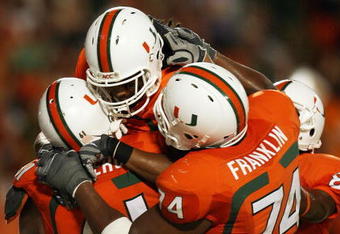 FORT LAUDERDALE, FL - OCTOBER 03: Wide receiver Travis Benjamin #3 of the Miami Hurricanes celebrates his touchdown with teammates Joel Figueroa #61 and Orlando Franklin #74 against the Oklahoma Sooners at Land Shark Stadium on October 3, 2009 in Fort Lauderdale, Florida. Miami defeated Oklahoma 21-20. (Photo by Doug Benc/Getty Images)