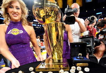 LOS ANGELES, CA - OCTOBER 27:  A member of the Laker Girls poses with the Larry O'Brien championship trophy and rings to be presented to the Los Angeles Lakers before the season opening game against the Los Angeles Clippers at Staples Center on October 27, 2009 in Los Angeles, California.  NOTE TO USER: User expressly acknowledges and agrees that, by downloading and or using this photograph, User is consenting to the terms and conditions of the Getty Images License Agreement. Mandatory Copyright Notice: Copyright 2009 NBAE  (Photo by Kevork Djansezian/Getty Images)