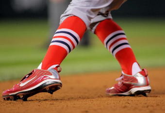 DENVER - SEPTEMBER 25:  A detail photograph of the shoes an sox of shortstop Brendan Ryan #13 of the St. Louis Cardinals as he leads off of first base against the Colorado Rockies at Coors Field on September 25, 2009 in Denver, Colorado. The Rockies defeated the Cardinals 2-1.  (Photo by Doug Pensinger/Getty Images)