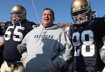 SOUTH BEND, IN - NOVEMBER 21: Head coach Charlie Weis of the Notre Dame Fighting Irish waits to enter the field with (L-R) Jimmy Clausen #7, Eric Olsen #55, Kyle McCarthy #28 and Scott Smith #41 before a game against the Univeristy of Connecticut Huskies at Notre Dame Stadium on November 21, 2009 in South Bend, Indiana. (Photo by Jonathan Daniel/Getty Images)