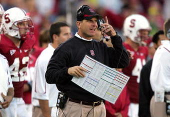 PALO ALTO, CA - NOVEMBER 07:  Stanford Cardinal head coach Jim Harbaugh listens to his headset during their game against the Oregon Ducks at Stanford Stadium on November 7, 2009 in Palo Alto, California.  (Photo by Ezra Shaw/Getty Images)