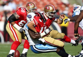 SAN FRANCISCO - NOVEMBER 08:  Alex Smith #11 of the San Francisco 49ers is tackled by William Hayes #95 of the Tennessee Titans during an NFL game on November 8, 2009 at Candlestick Park in San Francisco, California.  (Photo by Jed Jacobsohn/Getty Images)
