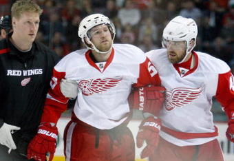 MONTREAL- NOVEMBER 21:  Niklas Kronwall #55 of the Detroit Red Wings is helped off of the ice after being tripped by Georges Laraque #17 of the Montreal Canadiens during the NHL game on November 21, 2009 at the Bell Centre in Montreal, Quebec, Canada.  (Photo by Richard Wolowicz/Getty Images)