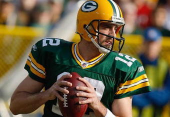 GREEN BAY, WI - NOVEMBER 22: Quarterback Aaron Rodgers #12 of the Green Bay Packers passes the football against the San Francisco 49ers at Lambeau Field on November 22, 2009 in Green Bay, Wisconsin. The Packers defeated the 49ers 30-24. (Photo by Scott Boehm/Getty Images)