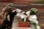 CORVALIS, OR - NOVEMBER 23:  Charles Favroth #11 of the University of Oregon Ducks attempts to tackle Shawn Jackson #34 of the Oregon State University Beavers during the 'Civil War' game at Reser Stadium on November 23, 2003 in Corvalis, Oregon. Oregon State won 45-24.  (Photo by Jon Ferrey/Getty Images) 