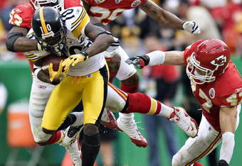 KANSAS CITY, MO - NOVEMBER 22: Wide receiver Santonio Holmes #10 of the Pittsburgh Steelers is tackled by Demorrio Williams #53 of the Kansas City Chiefs at Arrowhead Stadium on November 22, 2009 in Kansas City, Missouri.  The Chiefs defeated the Steelers 27-24.  (Photo by Wesley Hitt/Getty Images)