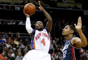 CHARLOTTE, NC - MARCH 28:  Boris Diaw #32 of the Charlotte Bobcats watches as Nate Robinson #4 of the New York Knicks goes to the basket during their game at Time Warner Cable Arena on March 28, 2009 in Charlotte, North Carolina.  NOTE TO USER: User expressly acknowledges and agrees that, by downloading and/or using this Photograph, user is consenting to the terms and conditions of the Getty Images License Agreement.  (Photo by Streeter Lecka/Getty Images)