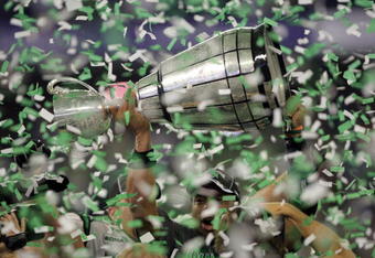 TORONTO, ON - NOVEMBER 25:  Quarterback Kerry Joseph #4 of the Saskatchewan Rough Riders hoists the trophy as confetti falls in celebration of a 23-19 victory over the Winnipeg Blue Bombers during the 95th Grey Cup on November 25, 2007 at the Rogers Centre in Toronto, Ontario, Canada.  (Photo by Harry How/Getty Images)