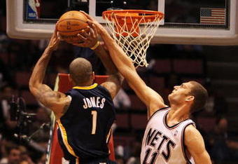 EAST RUTHERFORD, NJ - NOVEMBER 17:  Brook Lopez #11 of the New Jersey Nets blocks a shot by Dahntay Jones #1  of The Indiana Pacers during their game on November 17, 2009 at The Izod Center in East Rutherford, New Jersey.  NOTE TO USER: User expressly acknowledges and agrees that, by downloading and/or using this Photograph, user is consenting to the terms and conditions of the Getty Images License Agreement.  (Photo by Al Bello/Getty Images)