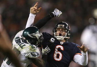 CHICAGO - NOVEMBER 22: Jay Cutler #6 of the Chicago Bears is hit by Quintin Mikell #27 of the Philadelphia Eagles as Cutler throws a 15-yard touchdown in the third quarter at Soldier Field on November 22, 2009 in Chicago, Illinois.  (Photo by Jonathan Daniel/Getty Images)