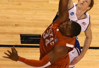 GREENSBORO, NC - MARCH 21:  Kyle Singler #12 of the Duke Blue Devils defends the basket against Dexter Pittman #34 of the Texas Longhorns during the second round of the NCAA Division I Men's Basketball Tournament at the Greensboro Coliseum on March 21, 2009 in Greensboro, North Carolina.  (Photo by Streeter Lecka/Getty Images)