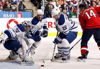 TORONTO - NOVEMBER 21:  Vesa Toskala #35, Ian White #7 and Francois Beauchemin #22 of the Toronto Maple Leafs grab the loose puck before Tomas Fleischmann #14 of the Washington Capitals during game action November 21, 2009 at the Air Canada Centre in Toronto, Ontario, Canada. (Photo by Abelimages/Getty Images)