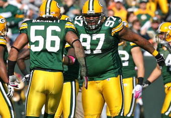 GREEN BAY, WI - OCTOBER 18: Johnny Jolly #97 and  Nick Barnett #56 of the Green Bay Packers celebrate a defensive stop against the Detroit Lions at Lambeau Field on October 18, 2009 in Green Bay, Wisconsin. The Packers defeated the Lions 26-0. (Photo by Jonathan Daniel/Getty Images)