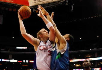 LOS ANGELES, CA - NOVEMBER 02:  Chris Kaman #35 of the Los Angeles Clippers is defended by Ryan Hollins #1 of the Minnesota Timberwolves during the second half at Staples Center on November 2, 2009 in Los Angeles, California. The Clippers defeated the Timberwolves 93-90. NOTE TO USER: User expressly acknowledges and agrees that, by downloading and/or using this Photograph, user is consenting to the terms and conditions of the Getty Images License Agreement.  (Photo by Jeff Gross/Getty Images)