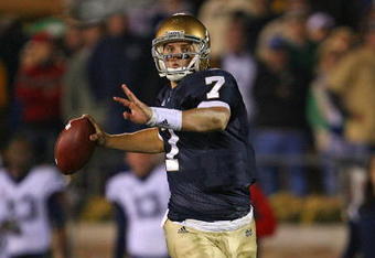 SOUTH BEND, IN - NOVEMBER 21: Jimmy Clausen #7 of the Notre Dame Fighting Irish looks for a receiver in the first overtime period against the Univeristy of Connecticut Huskies at Notre Dame Stadium on November 21, 2009 in South Bend, Indiana. Connecticut defeated Notre Dame 33-30 in double overtime. (Photo by Jonathan Daniel/Getty Images)