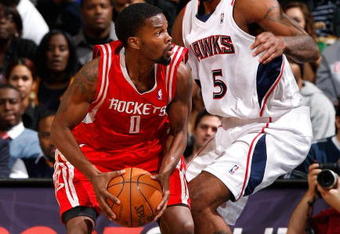 ATLANTA - NOVEMBER 20:  Josh Smith #5 of the Atlanta Hawks defends against Aaron Brooks #0 of the Houston Rockets at Philips Arena on November 20, 2009 in Atlanta, Georgia.  NOTE TO USER: User expressly acknowledges and agrees that, by downloading and/or using this Photograph, User is consenting to the terms and conditions of the Getty Images License Agreement.  (Photo by Kevin C. Cox/Getty Images)