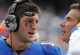 GAINESVILLE, FL - NOVEMBER 21: Quarterback Tim Tebow #15 of the Florida Gators talks with coach Urban Meyer against the Florida International University Golden Panthers, November 21, 2009 at Ben Hill Griffin Stadium in Gainesville, Florida.  (Photo by Al Messerschmidt/Getty Images)