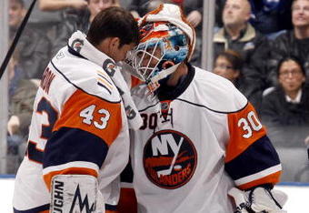TORONTO - NOVEMBER 23:  Martin Biron #43 congratulates Dwayne Roloson #30 of the New York Islanders on stopping 61 shots to win the game 4-3 in OT against the Toronto Maple Leafs during game action November 23, 2009 at the Air Canada Centre in Toronto, Ontario, Canada. (Photo by Abelimages/Getty Images)