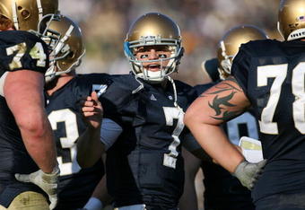 SOUTH BEND, IN - NOVEMBER 21: Jimmy Clausen #7 of the Notre Dame Fighting Irish calls a play in the huddle against the Univeristy of Connecticut Huskies at Notre Dame Stadium on November 21, 2009 in South Bend, Indiana. Connecticut defeated Notre Dame 33-30 in double overtime. (Photo by Jonathan Daniel/Getty Images)
