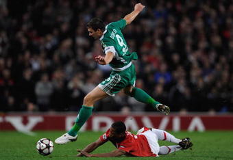 MANCHESTER, ENGLAND - SEPTEMBER 30:  Edin Dzeko of VfL Wolfsburg hurdles the challenge of Patrice Evra of Manchester United during the UEFA Champions League Group B match between Manchester United and VfL Wolfsburg at Old Trafford on September 30, 2009 in Manchester, England.  (Photo by Michael Regan/Getty Images)