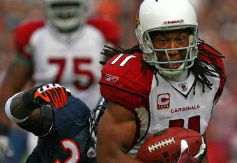 CHICAGO - NOVEMBER 08: Larry Fitzgerald #11 of the Arizona Cardinals shakes off a tackle attempt by Charles Tillman #33 of the Chicago Bears to score a touchdown at Soldier Field on November 8, 2009 in Chicago, Illinois. The aCardinals defeated the Bears 41-21. (Photo by Jonathan Daniel/Getty Images)