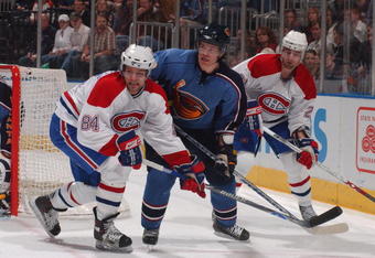 ATLANTA  -  MARCH 8:   Garnet Exelby #2 of the Atlanta Thrashers defends against Guillame Latendresse #84 and  Christopher Higgins #21 of the Montreal Canadiens on March 8, 2007 at Philips Arena in Atlanta, Georgia. (Photo by Scott Cunningham/Getty Images)  