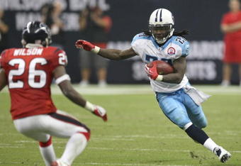 HOUSTON - NOVEMBER 23:  Running Back Chris Johnson #28 of the Tennessee Titans carries the ball against safety Eugene Wilson #26 of the Houston Texans on November 23, 2009  at Reliant Stadium in Houston, Texas.  The Titans won 20-17.  (Photo by Stephen Dunn/Getty Images)