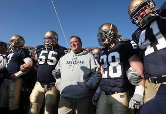 SOUTH BEND, IN - NOVEMBER 21: Head coach Charlie Weis of the Notre Dame Fighting Irish waits to enter the field with (L-R) Jimmy Clausen #7, Eric Olsen #55, Kyle McCarthy #28 and Scott Smith #41 before a game against the University of Connecticut Huskies at Notre Dame Stadium on November 21, 2009 in South Bend, Indiana. (Photo by Jonathan Daniel/Getty Images)