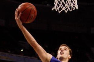 TAMPA, FL - MARCH 13:  Nick Calathes #33 of the Florida Gators makes a layup over Quantez Robertson #23 of the Auburn Tigers during the quaterfinal round of the SEC Men's Basketball Tournament on March 13, 2009 at The St. Pete Times Forum in Tampa, Florida.  (Photo by Chris Graythen/Getty Images)