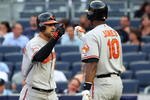 NEW YORK - JULY 20:  Nick Markakis #21 of the Baltimore Orioles celebrates his home run against the New York Yankees with teammate Adam Jones #10 on July 20, 2009 at Yankee Stadium in the Bronx borough of New York City.  (Photo by Jim McIsaac/Getty Images)