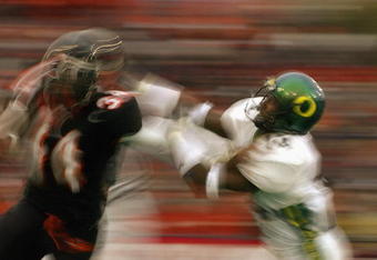 CORVALIS, OR - NOVEMBER 23:  Charles Favroth #11 of the University of Oregon Ducks attempts to tackle Shawn Jackson #34 of the Oregon State University Beavers during the 'Civil War' game at Reser Stadium on November 23, 2003 in Corvalis, Oregon. Oregon State won 45-24.  (Photo by Jon Ferrey/Getty Images) 