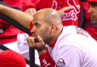 ST. LOUIS, MO - OCTOBER 10:  Albert Pujols #5 of the St. Louis Cardinals and teammates look on from the dugout after the Los Angeles win the NLDS  5-1 during the 2009 MLB Playoffs at Busch Stadium on October 10, 2009 in St. Louis, Missouri. (Photo by Dilip Vishwanat/Getty Images)