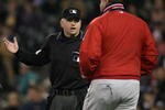 SEATTLE - SEPTEMBER 24:  Manager Mike Scioscia #14 of the Los Angeles Angels of Anaheim confers with umpire Mike Muchlinski #76, requesting a call be reviewed by instant replay against the Seattle Mariners at Safeco Field September 24, 2008 in Seattle, Washington. It was the first review in Mariners history resulting in a 2 minute 28 second delay. (Photo by Otto Greule Jr/Getty Images)