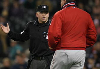 SEATTLE - SEPTEMBER 24:  Manager Mike Scioscia #14 of the Los Angeles Angels of Anaheim confers with umpire Mike Muchlinski #76, requesting a call be reviewed by instant replay against the Seattle Mariners at Safeco Field September 24, 2008 in Seattle, Washington. It was the first review in Mariners history resulting in a 2 minute 28 second delay. (Photo by Otto Greule Jr/Getty Images)