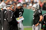 OAKLAND, CA - NOVEMBER 22:  Oakland Raiders head coach Tom Cable speaks to his new starting quarterback Bruce Gradkowski #5 while newly benched quarterback JaMarcus Russell #2 looks on during their game against the Cincinnati Bengals at Oakland-Alameda County Coliseum on November 22, 2009 in Oakland, California.  (Photo by Ezra Shaw/Getty Images)