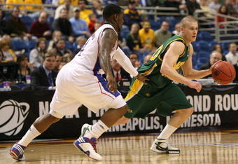MINNEAPOLIS - MARCH 20:  Ben Woodsie #4 of the North Dakota State Bison drives against Sherron Collins #4 of the Kansas Jayhawks in the first half during the first round of the NCAA Division I Men's Basketball Tournament at the Hubert H. Humphrey Metrodome on March 20, 2009 in Minneapolis, Minnesota.  (Photo by Jonathan Daniel/Getty Images)
