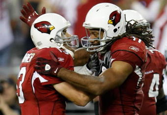 GLENDALE, AZ - NOVEMBER 15:  Kurt Warner (L) ) #13 of the Arizona Cardinals celebrates a touchdown with Larry Fitzgerald #11 in the second half against the Seattle Seahawks at University of Phoenix Stadium on November 15, 2009 in Glendale, Arizona. The Cardinals defeated the Seahawks 31-20.  (Photo by Jeff Gross/Getty Images)