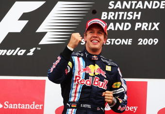 NORTHAMPTON, UNITED KINGDOM - JUNE 21:  Sebastian Vettel of Germany and Red Bull Racing celebrates on the podium after winning the British Formula One Grand Prix at Silverstone on June 21, 2009 in Northampton, England.  (Photo by Clive Mason/Getty Images)