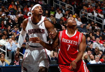 ATLANTA - NOVEMBER 20:  Kyle Lowry #7 of the Houston Rockets against Josth Smith #5 of the Atlanta Hawks at Philips Arena on November 20, 2009 in Atlanta, Georgia.  NOTE TO USER: User expressly acknowledges and agrees that, by downloading and/or using this Photograph, User is consenting to the terms and conditions of the Getty Images License Agreement.  (Photo by Kevin C. Cox/Getty Images)